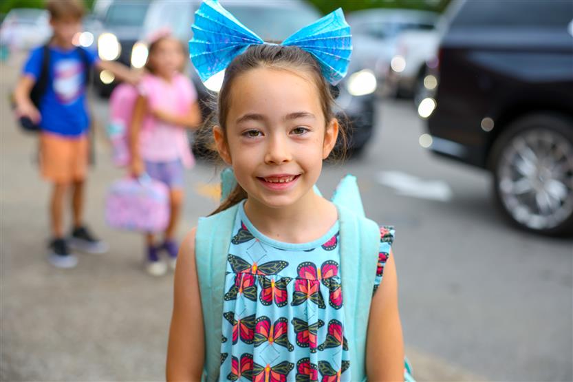 Students smile on the first day of kindergarten